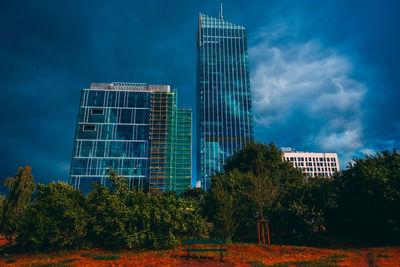 Low angle view of modern buildings against blue sky