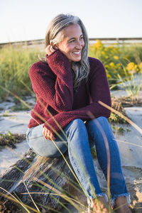 Gray haired woman enjoying the beach at sunset