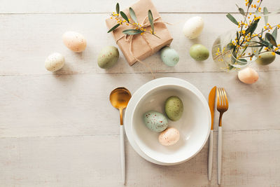 High angle view of breakfast on table. easter breakfast - white bowl with easter eggs