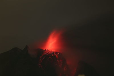 Red mountain against sky at night