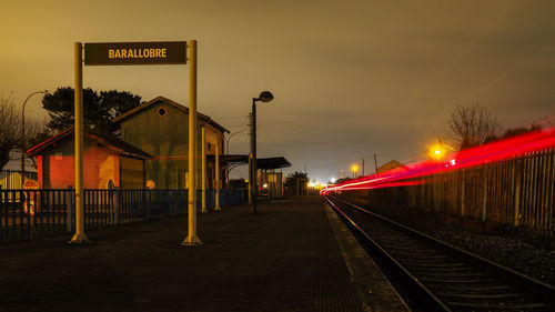 Train at railroad station against sky at night