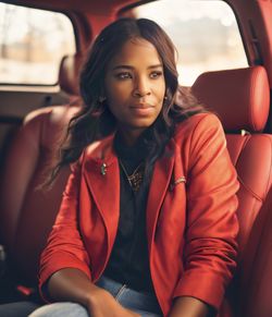 Portrait of young woman sitting in car