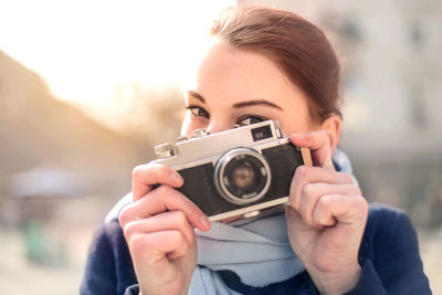 Portrait of woman photographing