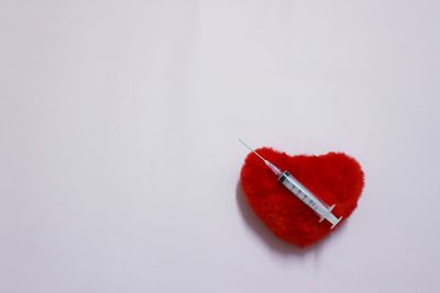 High angle view of red umbrella over white background
