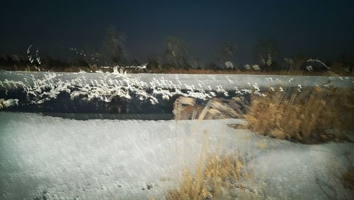 Scenic view of frozen lake against sky