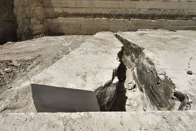 High angle view of old abandoned stack on wood against wall