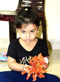 Portrait of cute girl sitting at home