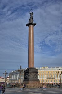 Statue of fountain in city against sky