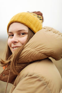 Portrait of young woman smiling outdoors