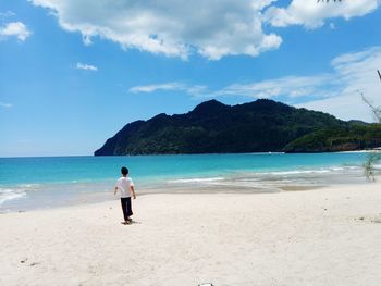 Full length of man on beach against sky