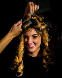 Portrait of young woman with hair curlers