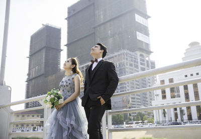 People standing by buildings in city