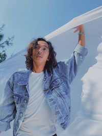 Young man holding textile outdoors