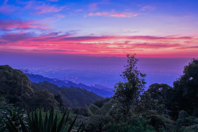 Scenic view of mountains against sky at sunset