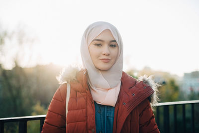 Portrait of confident young muslim woman against clear sky