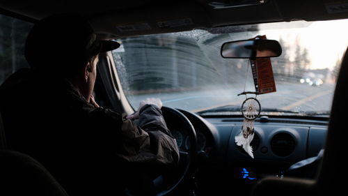 Rear view of man driving car