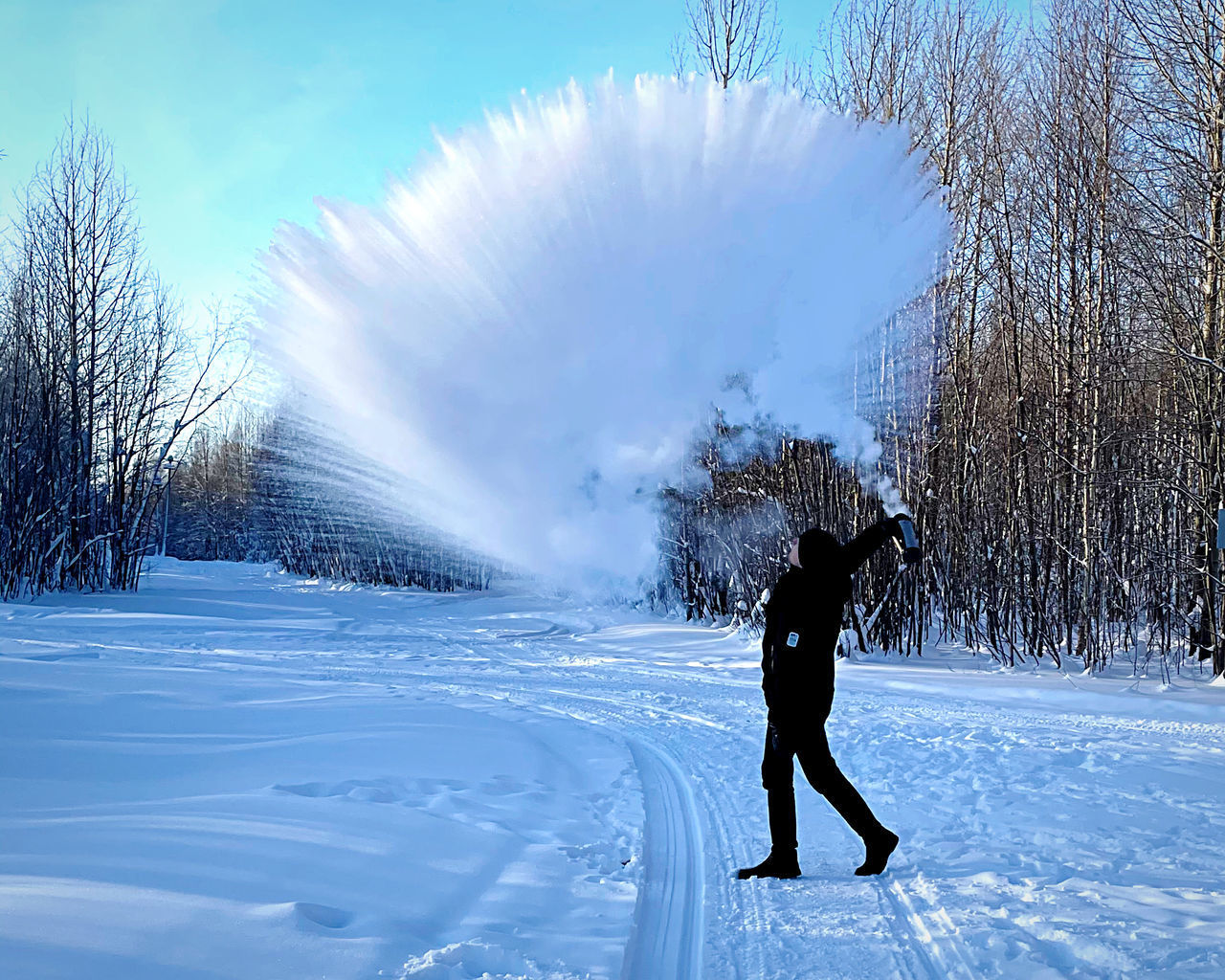 FULL LENGTH OF WOMAN ON SNOW FIELD AGAINST SKY DURING WINTER