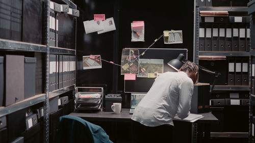 Rear view of woman sitting at home