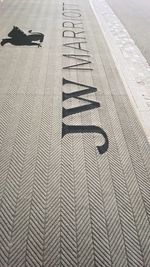 High angle view of footpath by street in city