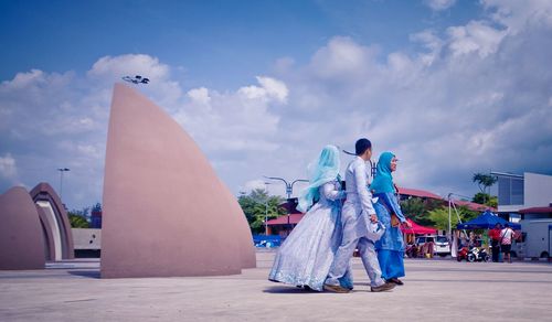 Panoramic view of people enjoying against sky