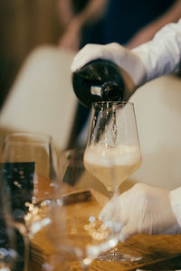 Cropped hand of pouring wine