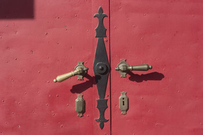 Close-up of fire hydrant against red wall