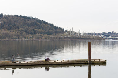 Pier on lake against sky