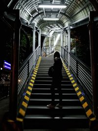 Rear view of man walking on subway station