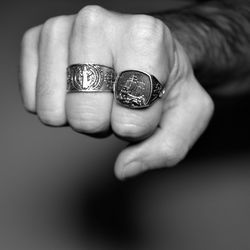 Cropped image of hand wearing carved rings