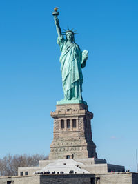 Low angle view of statue against blue sky