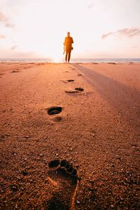 Rear view of man standing on beach