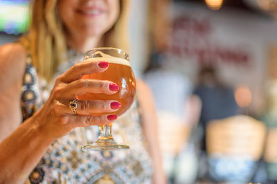 Close-up of woman with beer