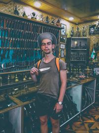 Portrait of young man standing in store