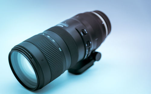 Close-up of camera on table against white background