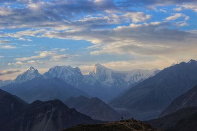 Scenic view of mountains against cloudy sky