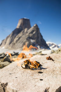 Flaming pile of toilet paper in remote mountains, leave no trace.