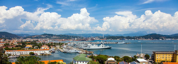 High angle view of harbor by city against sky