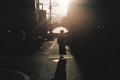 Woman walking on road in city
