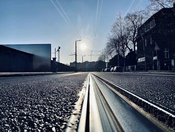 Surface level of railroad tracks on berlin wall against sky