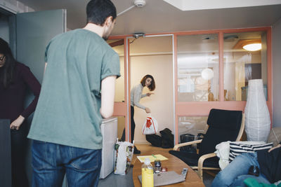 Rear view of couple standing at home