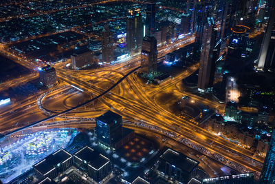 High angle view of city lit up at night