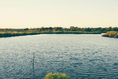 View of calm lake against clear sky