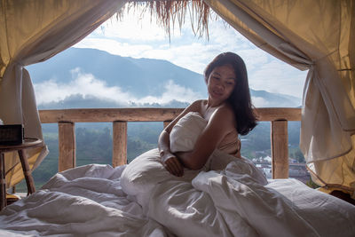 Woman sitting on bed