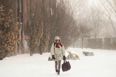 Person walking on snow covered landscape