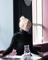 Beautiful woman sitting at restaurant table