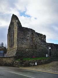 View of old ruin building against cloudy sky