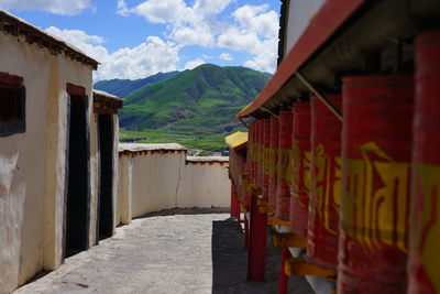 Footpath amidst buildings against sky