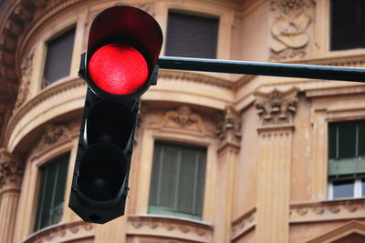 Low angle view of road sign against building