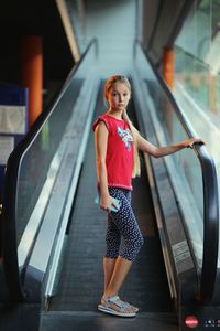 Portrait of a young girl in front of an escalator 