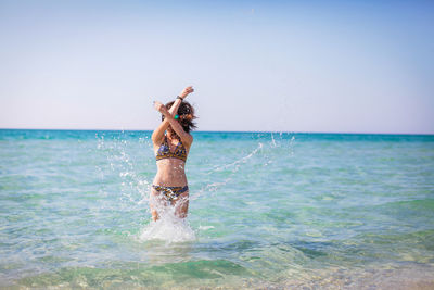 Woman enjoying in sea at beach
